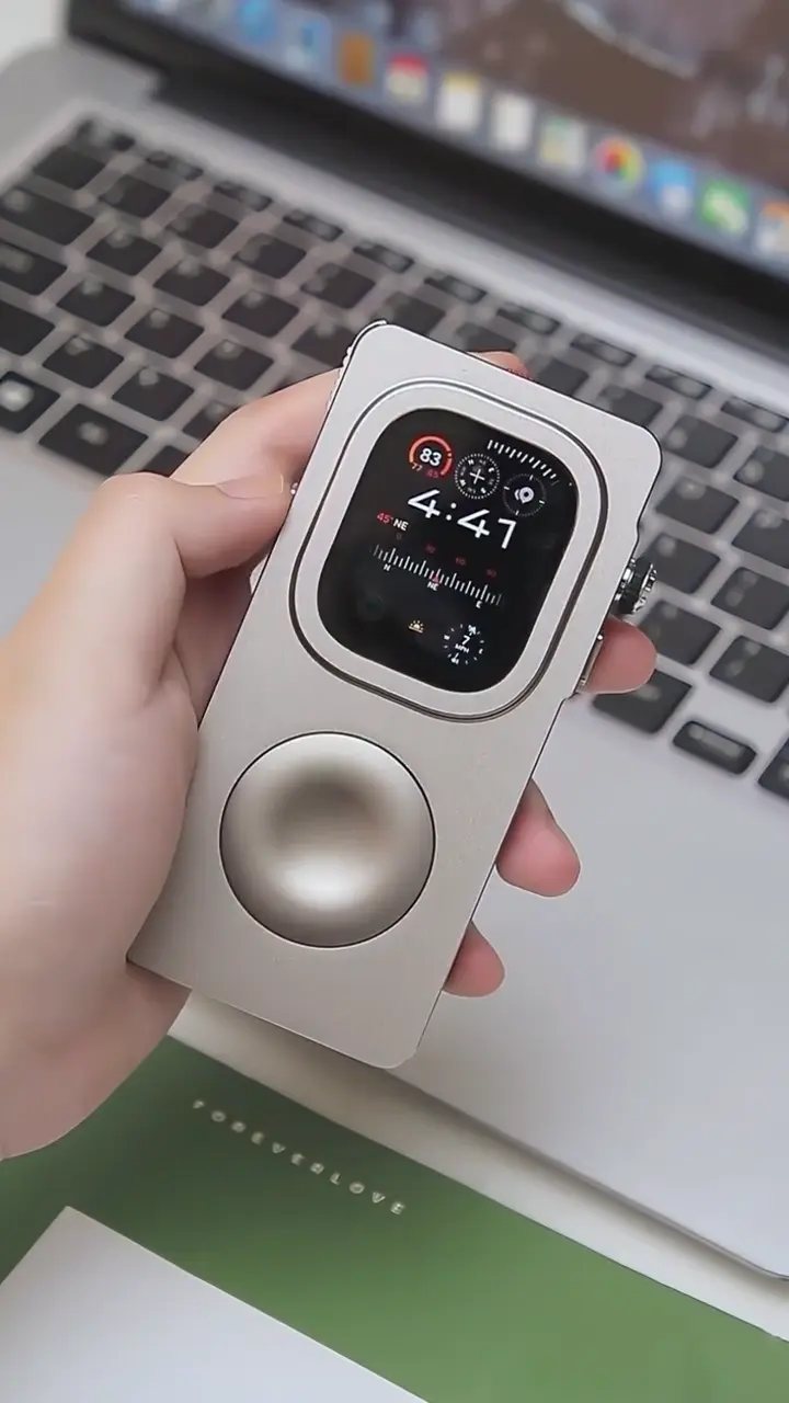 Angled view of a silver Precision case resting in a hand beside a laptop
